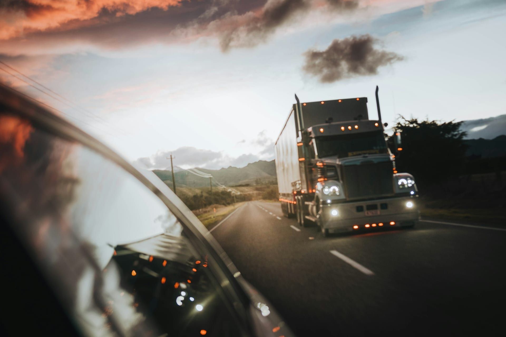 Class 8 semi truck on highway at golden hour, side profile