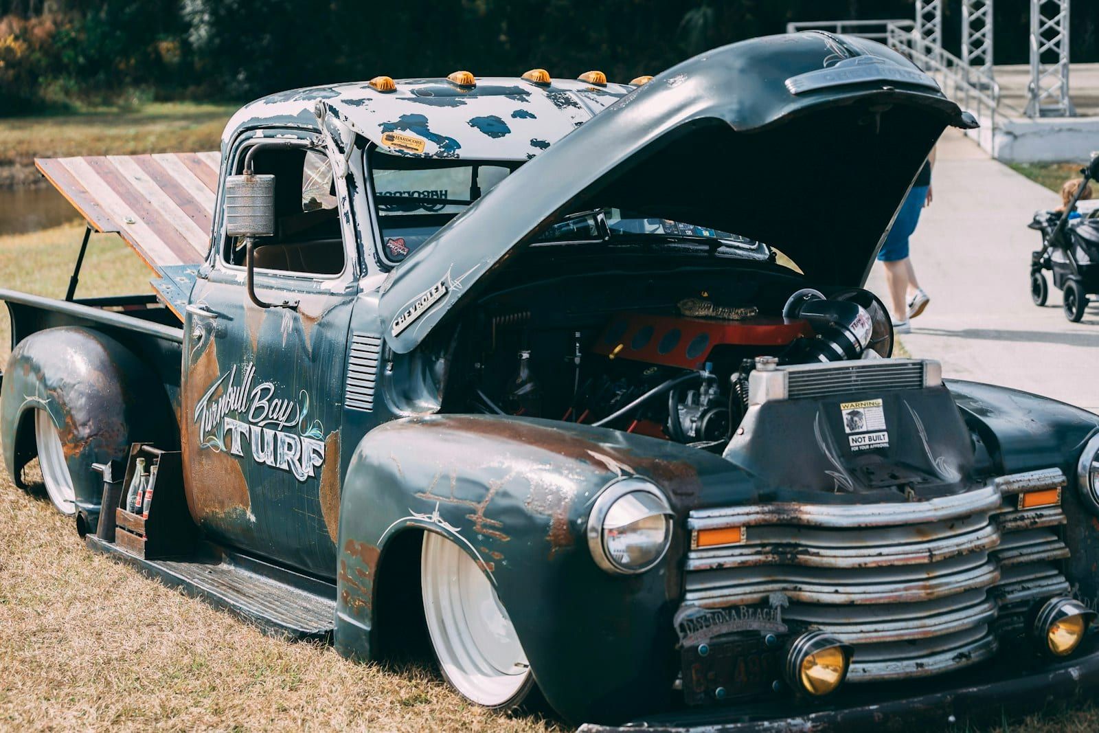 Pickup engine bay — compressor mount remains in standard position for spare-tire-mount installs